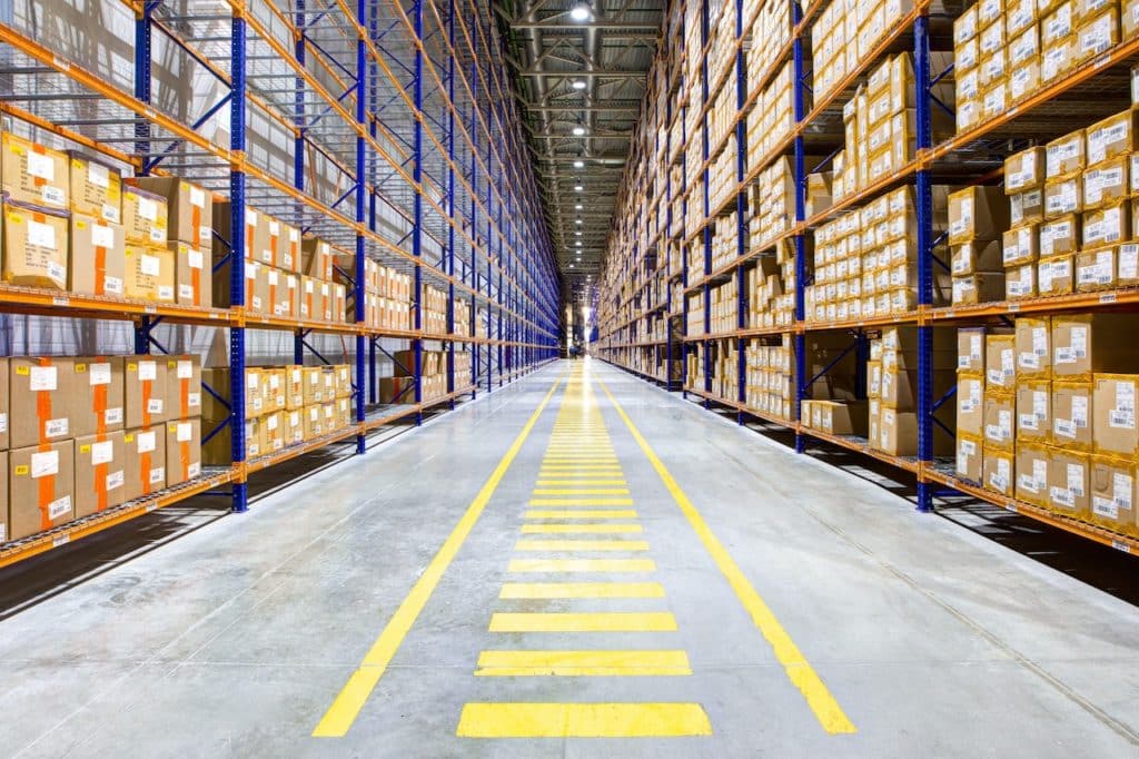 Warehouse with high shelves representing logistics and inventory operations.