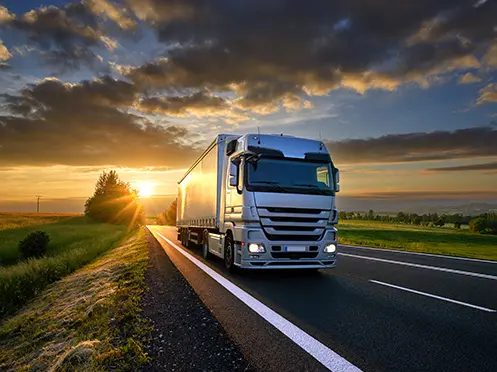 Truck driving on a highway illustrating road transport operations.